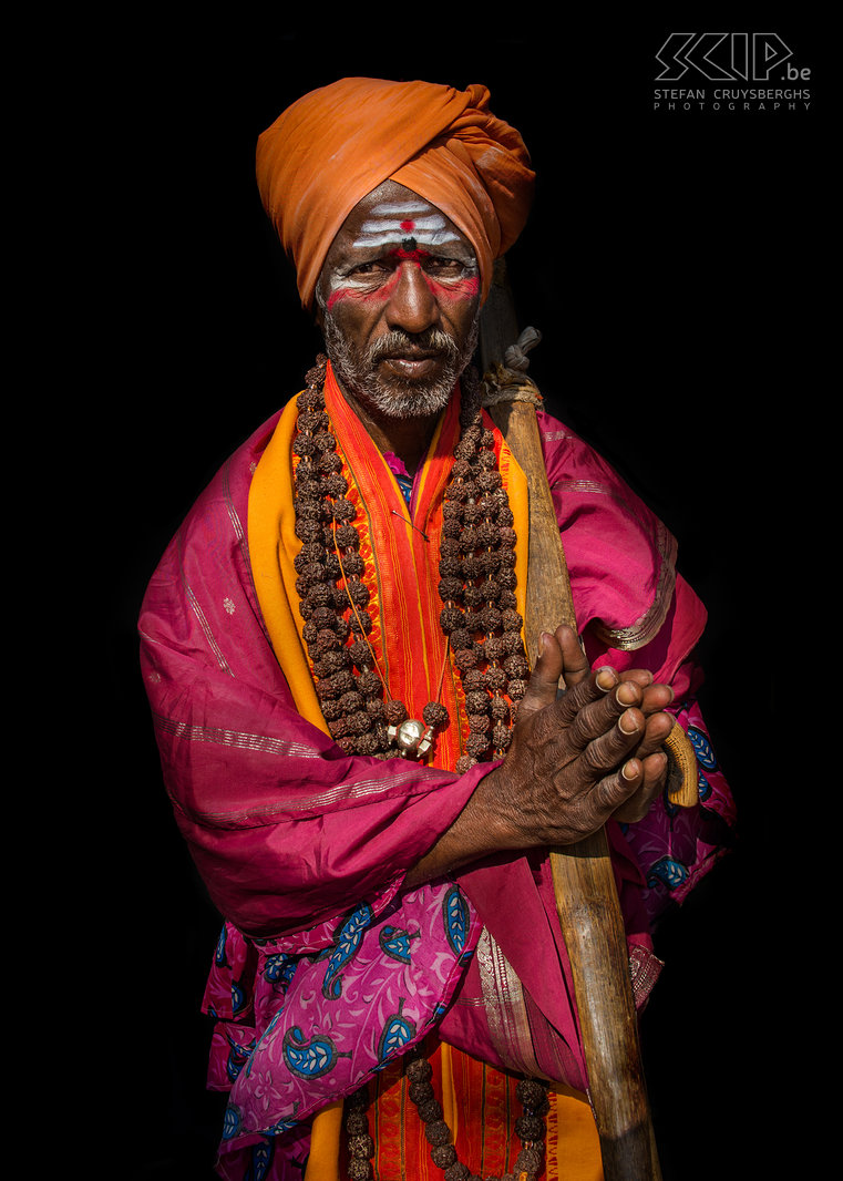 Hampi - Sadhu Hampi is also a the home to several sadhus who are supported by donations from local people and tourists. In Hinduism a sadhu (sanyasi) is a religious ascetic or holy man who left behind all material attachments and who focusses on the spiritual practice of Hinduism. This is one of the turban clad sadhus in Hampi. They wear brightly coloured clothes and they paint their face with white and red patterns. Stefan Cruysberghs